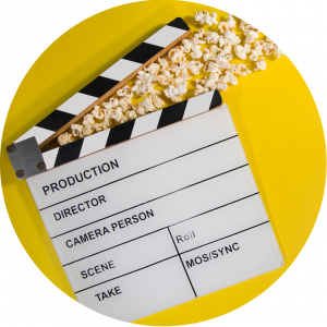 movie clapboard with popcorn coming out of top